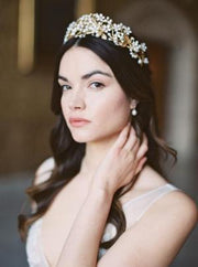 A beautiful bride wearing a Noon on the Moon bridal crown made of handpainted flowers and pearls