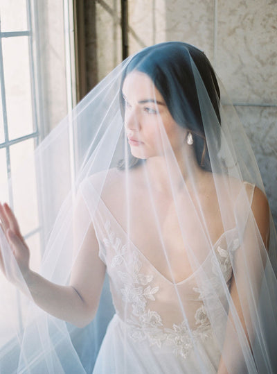 Bride wearing an elegant veil from the wedding veil collection.