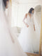 Side profile of a bride looking at her reflection in a mirror at Graydon Hall Manor. The AMELIE bridal veil with blusher is over her face, the blusher falling to the waist. 