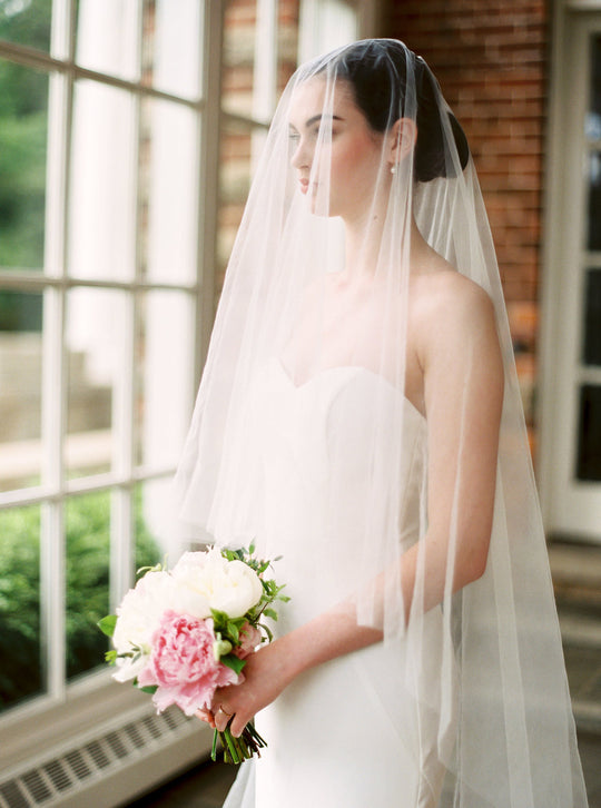 Sheer wedding veil with blusher.