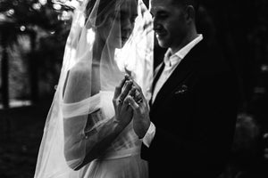 Bride wearing the ARIA sheer wedding veil with blusher with an off-the-shoulder wedding dress.