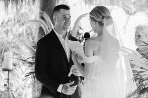 Bride wearing the ARIA sheer wedding veil with blusher with an off-the-shoulder wedding dress during wedding ceremony.