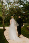 Bride wearing the ARIA sheer wedding veil with blusher with an off-the-shoulder wedding dress.
