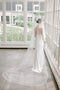 Bride wearing the ARIA sheer wedding veil with blusher in cathedral length.