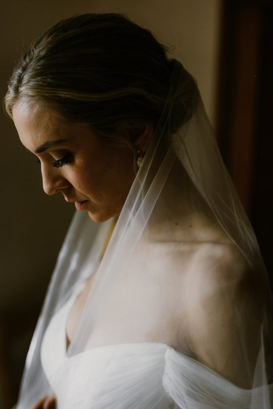 Bride wearing the ARIA sheer wedding veil with blusher with an off-the-shoulder wedding dress.