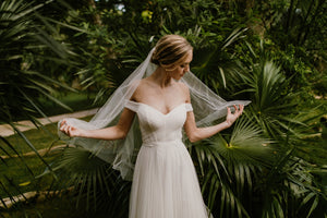 Bride wearing the ARIA sheer wedding veil with blusher with an off-the-shoulder wedding dress.