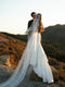 Rear view of the bride with the Dream butterfly veil, focusing on the fabric gathering elegantly around the bridal hairstyle and showing the full length of the long train.