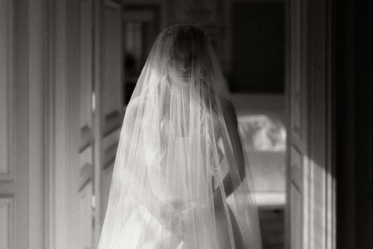 Silk wedding veil on beautiful bride in French chateau.