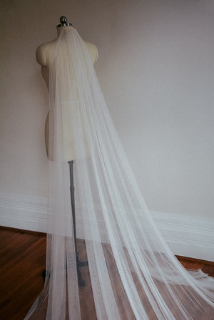 A side shot of the Isabelle silk veil, showing the light gathering at the comb and the soft, flowy nature of the tulle.