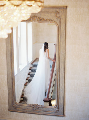 Cathedral silk wedding veil and dramatic wedding gown photographed on Graydon Hall staircase.