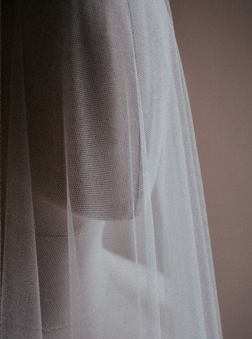 Close up image of the Monique silk wedding veil with blusher, showcasing the delicate soft texture of the French silk tulle. 