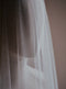 Close up image of the Monique silk wedding veil with blusher, showcasing the delicate soft texture of the French silk tulle. 