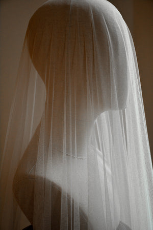The Monique silk wedding veil shown draped over a head mannequin. The soft tulle gently drapes over the headform. 