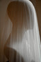 The Monique silk wedding veil shown draped over a head mannequin. The soft tulle gently drapes over the headform. 