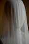 The Monique silk wedding veil shown softly draping over a headform. 