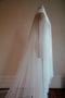 Profile image of the Monique silk wedding veil with blusher shown on a dress mannequin. The veil softly flows over the form.