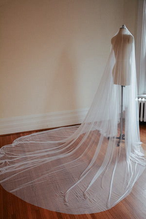 Back view of the Monique silk wedding veil on a dress form. The images showcases with extra-wide train of the cathedral silk veil. 