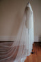 Profile view of the Monique silk wedding veil with blusher, showing the wide, fanned out train of the veil and dramatic blusher. 
