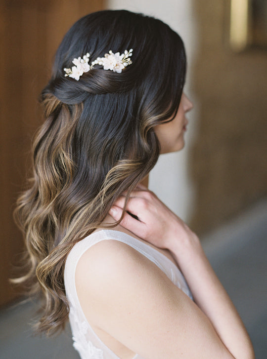 Blush bridal hair combs worn in a half-up hairstyle.