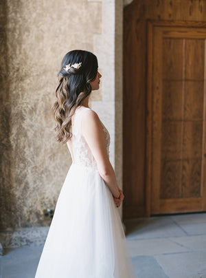 Blush bridal hair combs worn in half-up hairstyle.