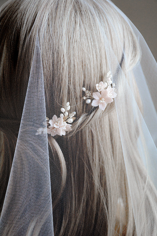 Blush bridal hair pins styled with veil.