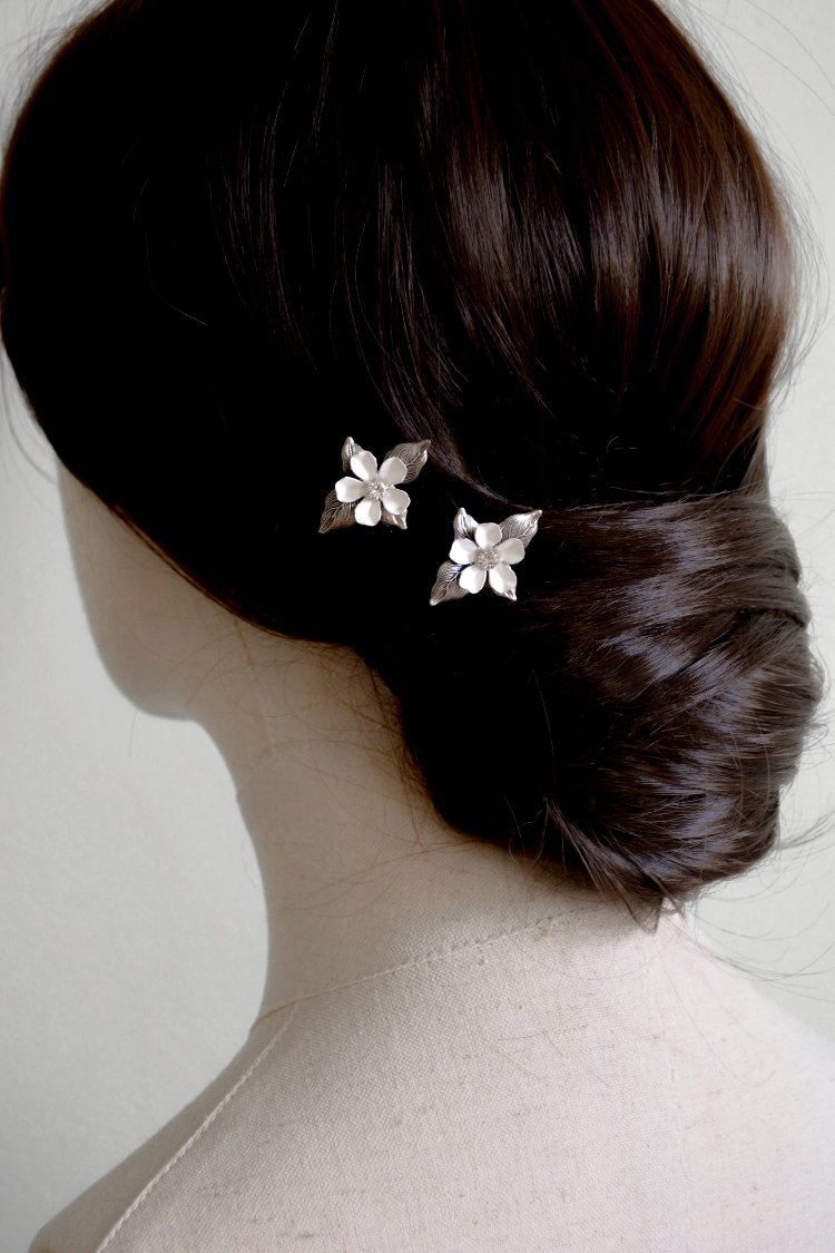 Floral hair pins worn in updo.