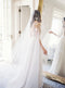 A bride wearing the REVERIE wedding veil with butterflies and lace wedding dress; she is standing in front of the mirror in the Graydon Hall bridal suite. 