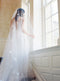 A bride wearing the REVERIE wedding veil with butterflies while standing on the Graydon Hall staircase. 