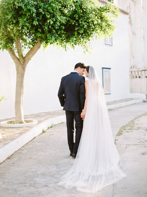 Rear view of a bride wearing the Talitha veil, showcasing the softness of English net. 