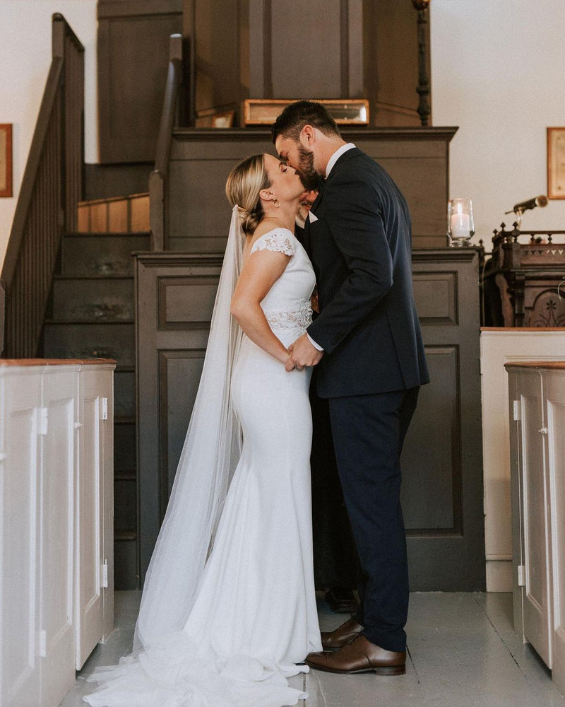 An elegant bride wearing the Talitha wedding veil low in her hair.