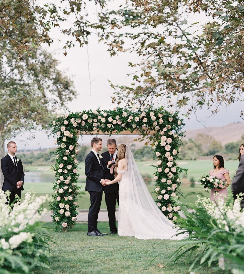 Side view of the bride wearing the Talitha sheer English net veil draping softly behind the shoulders.