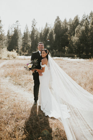 The Talitha wedding veil shown on a bride, showcasing the beautiful wide train.