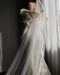 The Talitha veil show on a bride wearing a fitted bow detail dress. The veil is soft and sheer and drapes beautifully. 