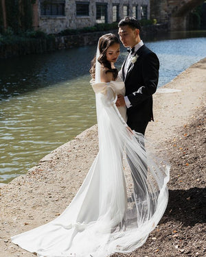 Elegant bride in the Talitha single-tier veil, showcasing its softness and wide, rounded train.