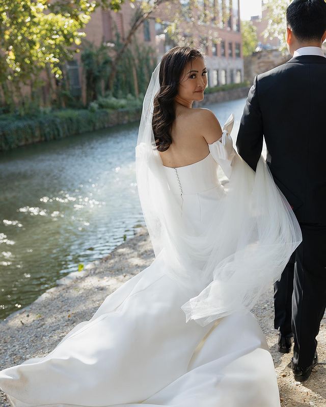 The Talitha modern long wedding veil shown on a bride with long brown hair. 