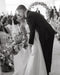 Black and white photo of a bride and groom at a wedding ceremony.