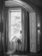 Intimate bridal portrait at Graydon Hall. Black and white photo shows the Cassandra Veil's sheer Italian tulle train pooling as the bride sits on a deep window seat, backlit by sunlight. 