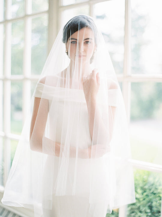 Sheer wedding veil with blusher.