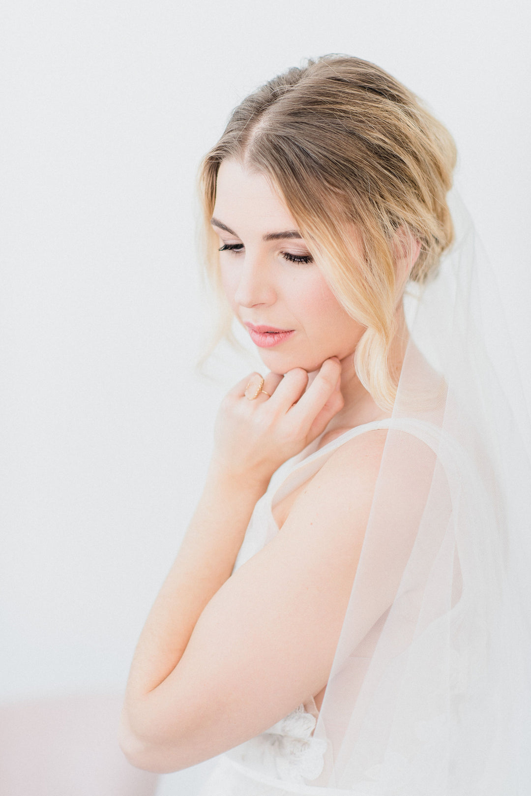 Sheer wedding veil with blusher.