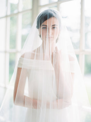 Sheer wedding veil with blusher.