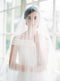 Sheer wedding veil with blusher.