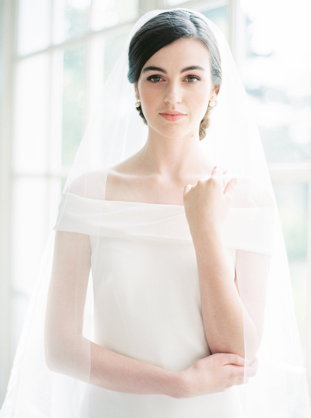 Sheer wedding veil with blusher.