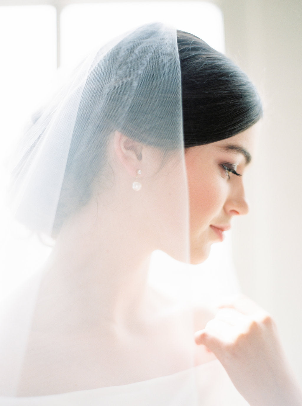 Sheer wedding veil with blusher.