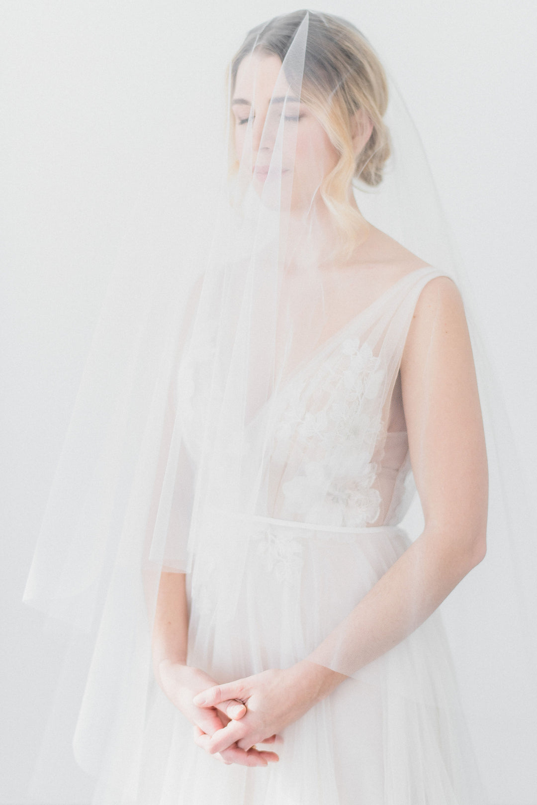 https://www.noononthemoon.com/cdn/shop/products/JENNY-sheer-wedding-veil-with-blusher-6.jpg?v=1679338708&width=1080