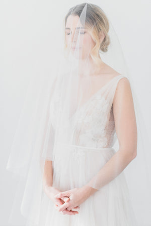 Sheer wedding veil with blusher.