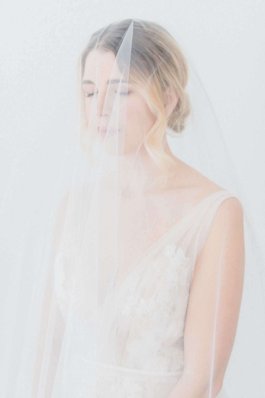 Sheer wedding veil with blusher.