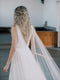 KAJA draped bridal cape veil styled with a lace gown and half up hairstyle.