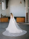 KAJA draped bridal cape veil, extra wide cape train fanned out behind the bride.