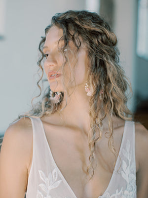 Close-up of the bride's face showcasing the KYOTO Floral Drop Earring with pink flowers and pearls.