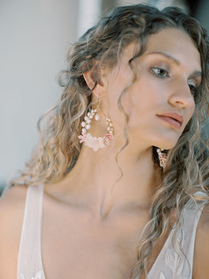Side profile close-up photo of a bride wearing the KYOTO Floral Bridal Earrings with curly hair and a V-neck lace wedding dress.